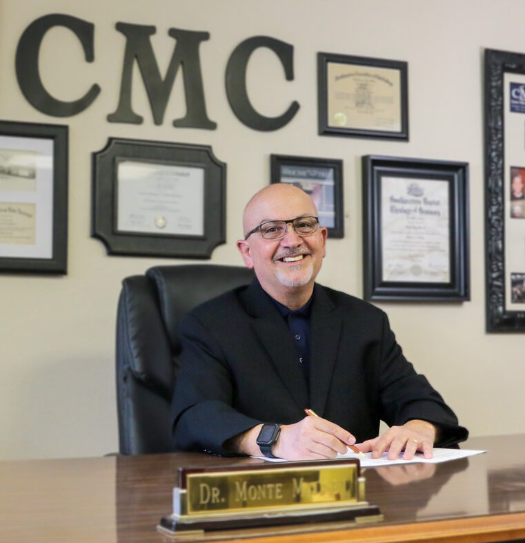 President of CMC, Dr. Monte Madsen, signs the MOU